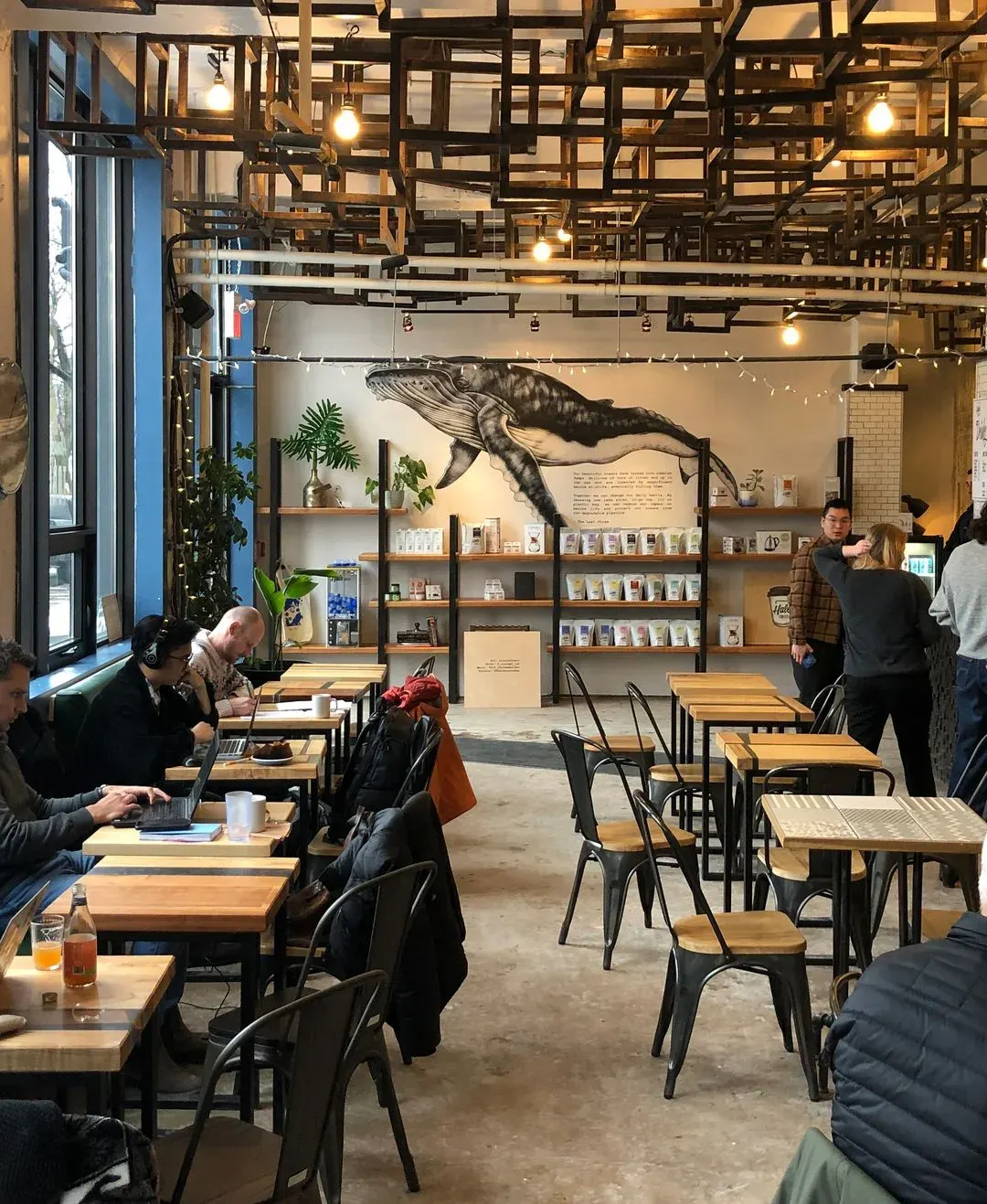 A whale mural printed in a busy cafe